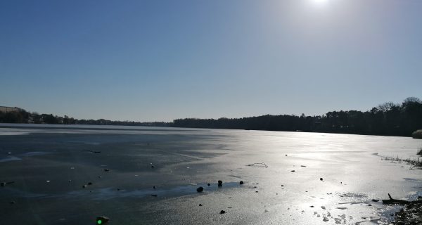 Frozen winter lake symbolizing rest, reflection, and finding calm during dark seasons.