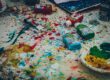 Colorful table with open paint tubes all over it. Photo by Ricardo Viana